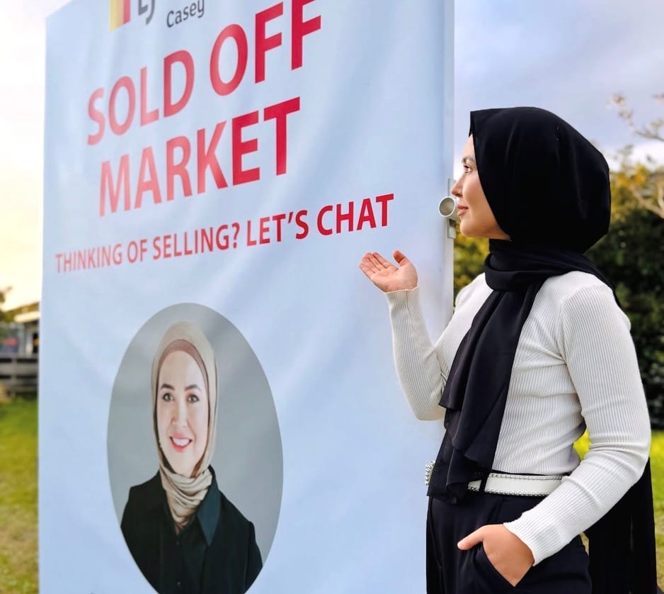 Fatima gesturing to her 'Sold off market' banner in Hampton Park.