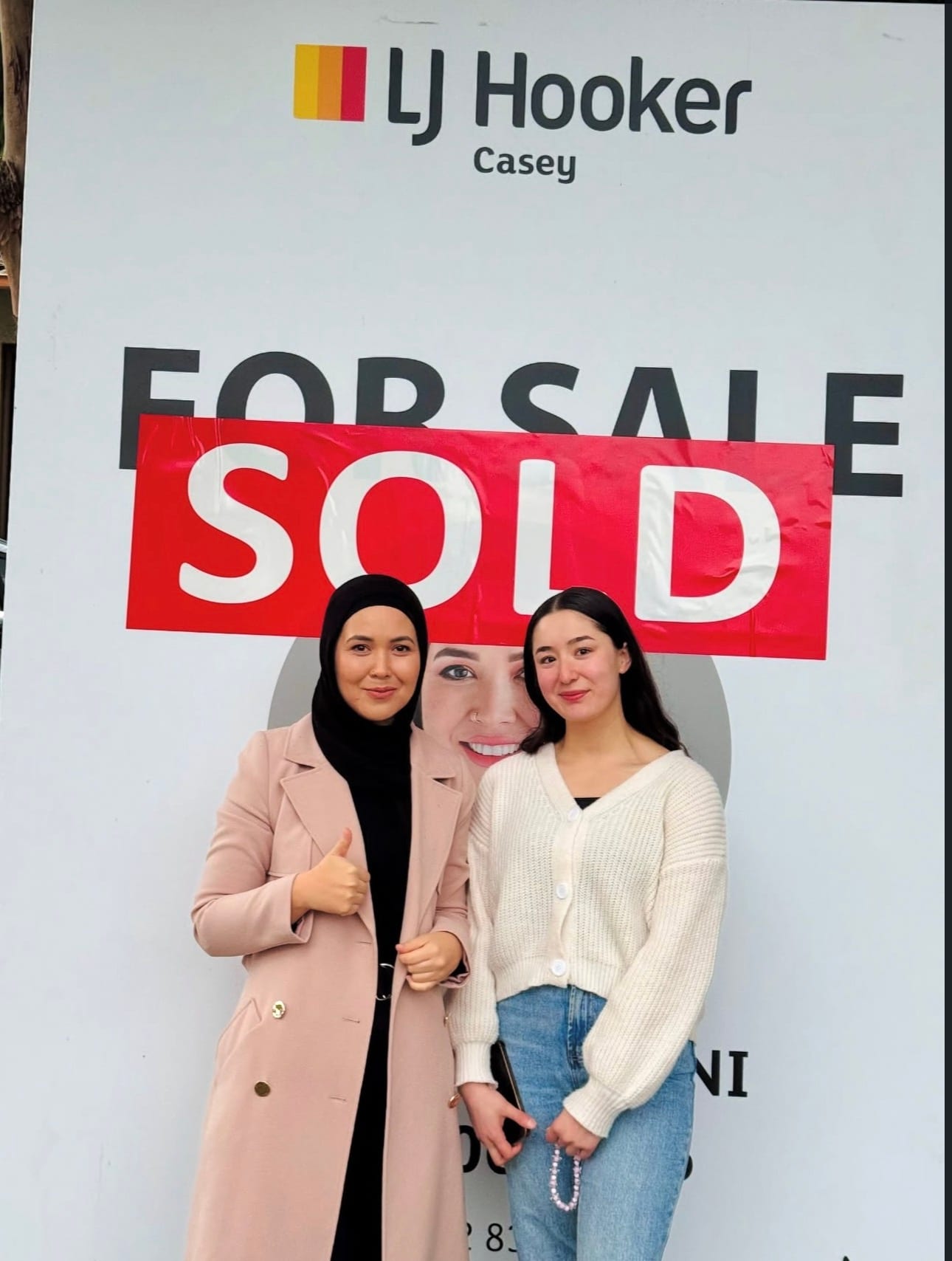 Fatima Yazdani beside one of her LJ Hooker Casey SOLD boards in Melbourne's south-east.